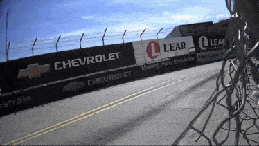 a race track with chevrolet and lear advertising