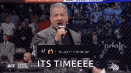 a man speaking into a microphone with the words " it 's timeeee " on the bottom