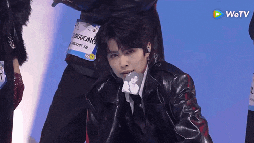 a man in a black leather jacket has a name tag that says ' kingdong ' on it