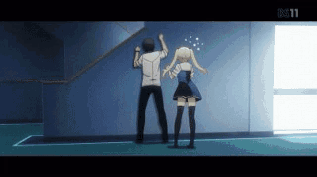 a man and a woman are standing next to each other in a hallway .