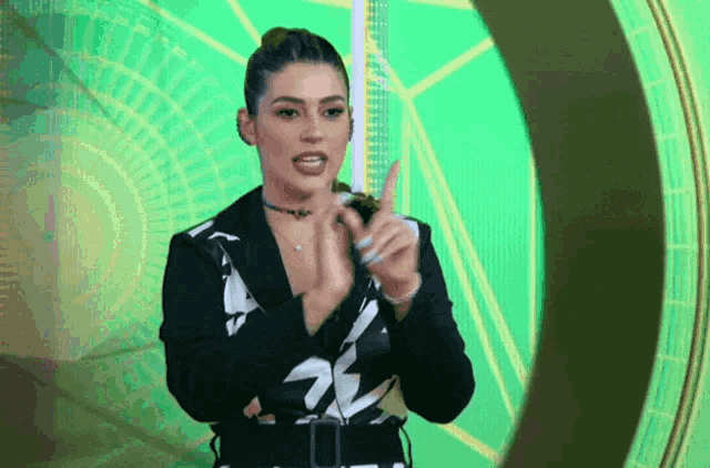 a woman wearing a black and white jacket with the letter s on it