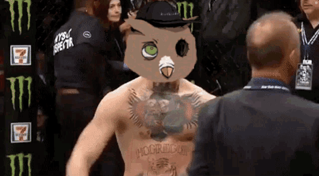 a man with an owl on his head has the word mcgregor tattooed on his chest