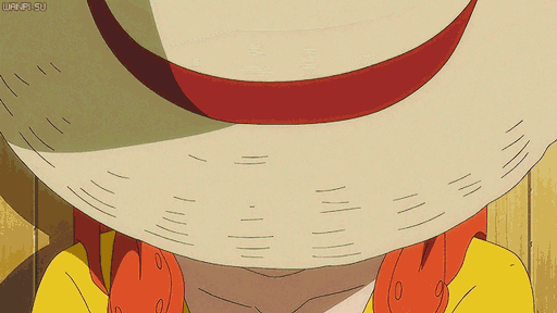 a close up of a person wearing a straw hat with a red ribbon and a yellow shirt
