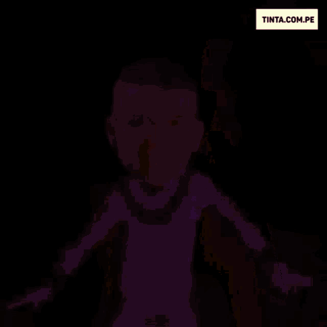 a man in a purple suit is dancing in front of a fire .
