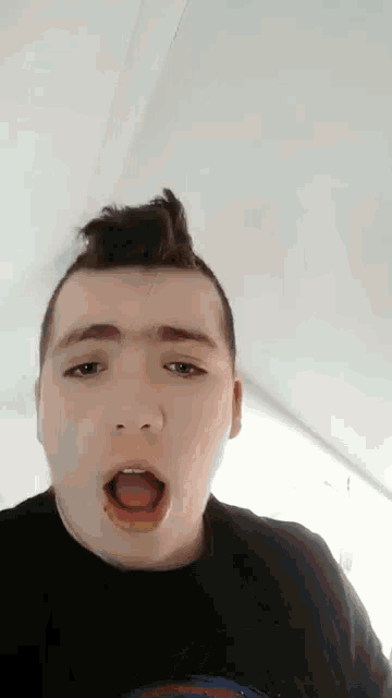 a young man is making a funny face with his tongue out
