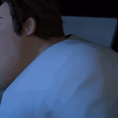 a close up of a man 's neck and back in a blue shirt .
