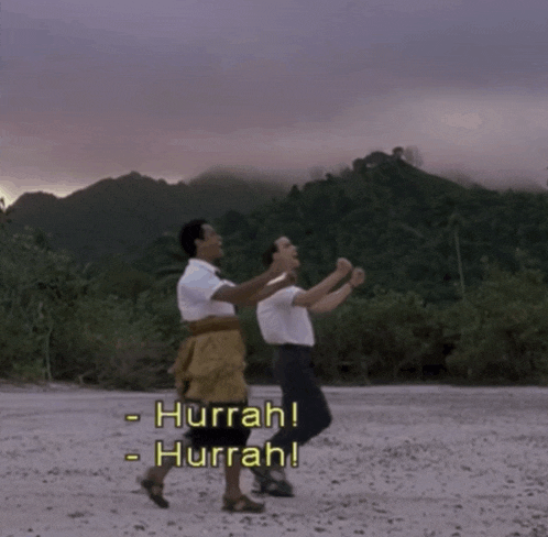 two men are dancing on a beach with hurrah written on the bottom