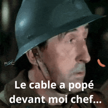 a man wearing a helmet with the words le cable a pope devant moi chef written below him