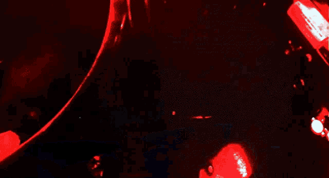 a close up of a person 's hand with blood coming out of it in a dark room