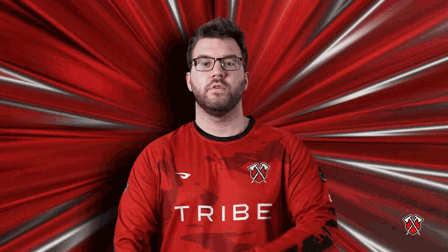 a man wearing glasses stands in front of a red background with the words fear the tribe