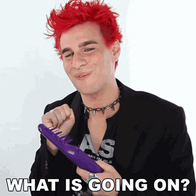 a man with red hair is holding a purple comb with the words what is going on written below him