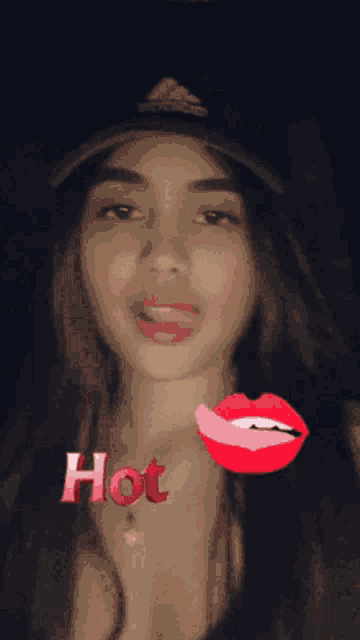a woman wearing a hat with the word hot above her lips