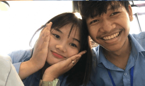 a boy and a girl are posing for a picture and the girl has a watch on her wrist