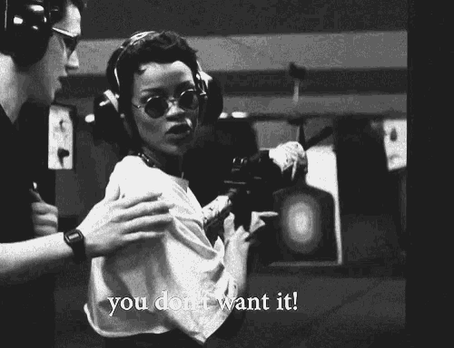 a black and white photo of a woman holding a gun with the words " you do n't want it "