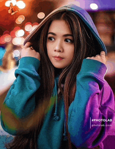 a girl wearing a blue and purple hoodie with a photolab logo on the bottom