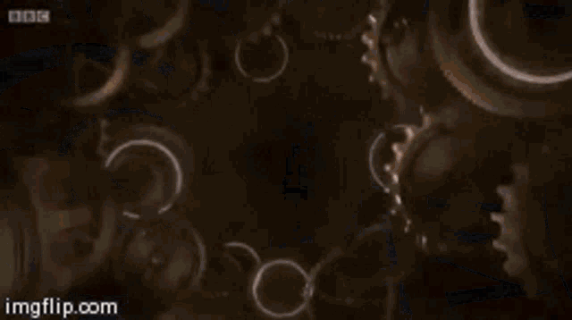 a swirl is surrounded by gears and a bbc logo is visible