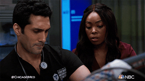 a man with a stethoscope around his neck is wearing a chicago medical center uniform