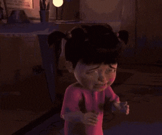 boo from monsters inc is crying in a pink shirt .