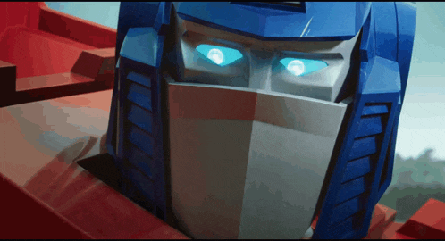 a close up of a blue and white robot with blue eyes