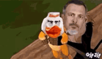 a man is holding a stuffed duck with a coca cola bottle on it .