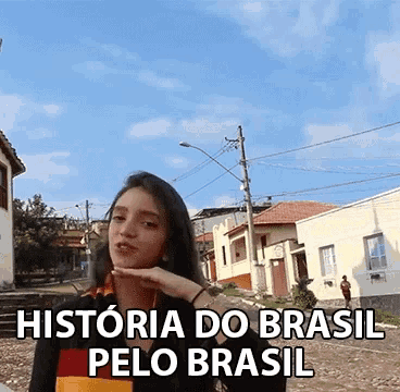 a woman stands in front of a sign that says historia do brasil