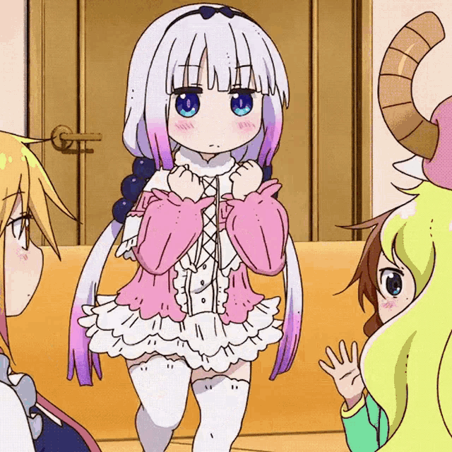 a girl in a pink and white dress is standing next to another girl with horns
