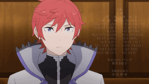 a man with red hair and blue eyes is standing in front of a list of names