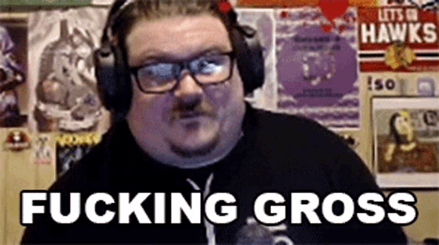a man wearing headphones and glasses is saying fucking gross
