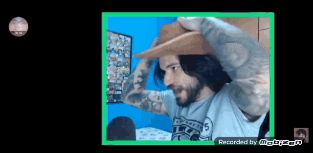 a man with a beard is wearing a cowboy hat