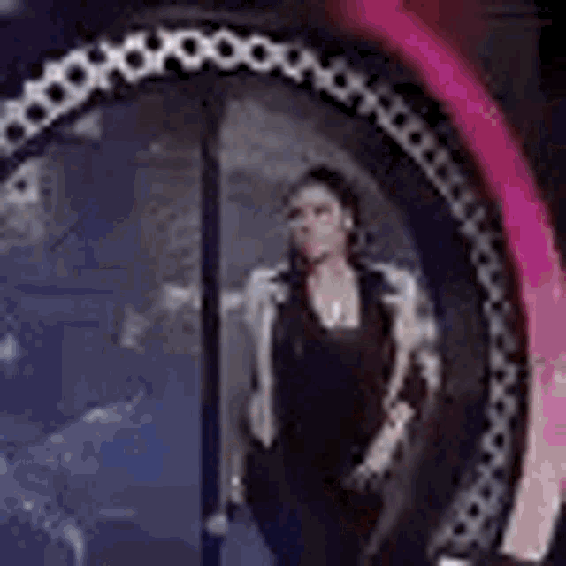 a woman is standing in a circle with a microphone in her mouth .