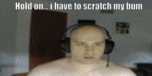 a bald man wearing headphones says hold on ... i have to scratch my bum .