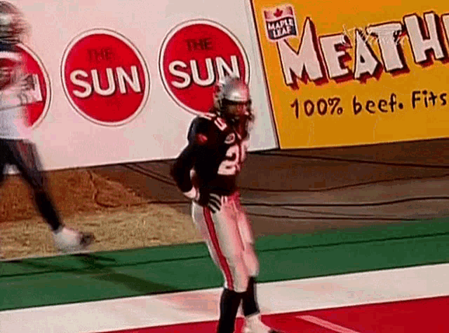 a football player with the number 2 on his jersey is standing on the field