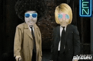 a man with an afro and a woman with hypnotic glasses