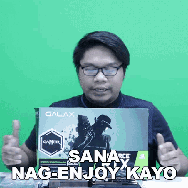 a man is holding a box that says galax