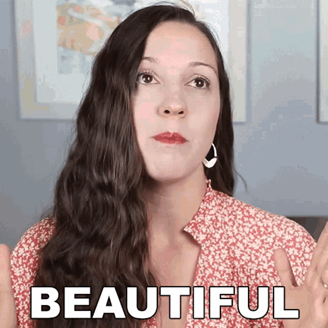 a woman in a red and white floral shirt with the words beautiful behind her