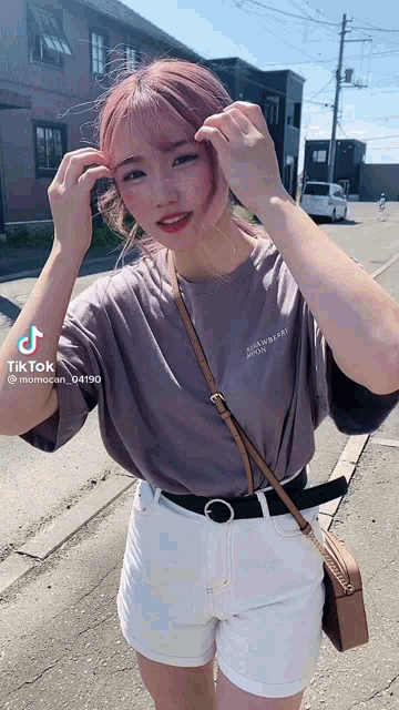a girl with pink hair is wearing a gray t-shirt that says " strawberry " on it