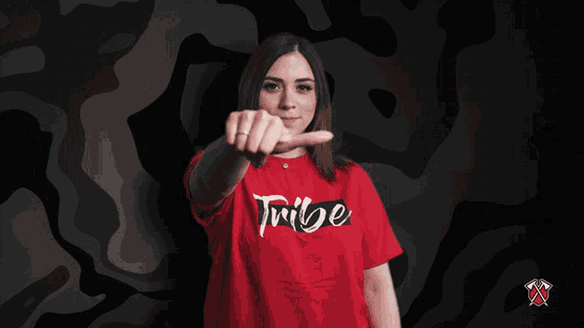 a woman wearing a red t-shirt that says tribe on it