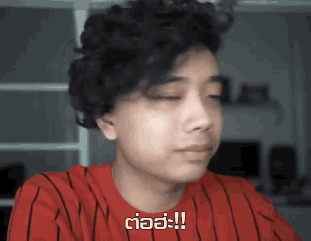 a young man in a red and black striped shirt says ciao