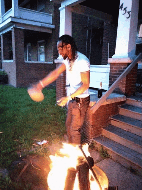 a man is standing in front of a house with the number 453 on the porch