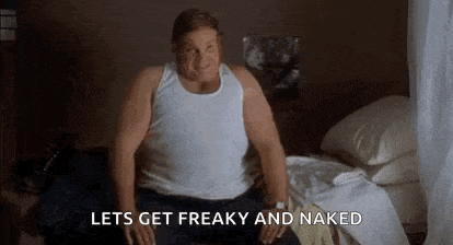 a fat man in a white tank top is sitting on a bed and says `` lets get freaky and naked '' .