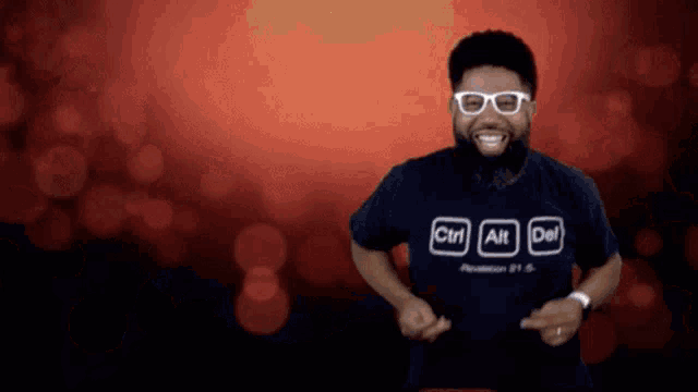 a man wearing a shirt that says ctrl alt del is dancing