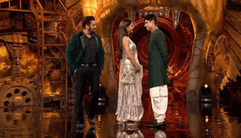 a man and a woman are standing next to each other on a stage in front of a tunnel .