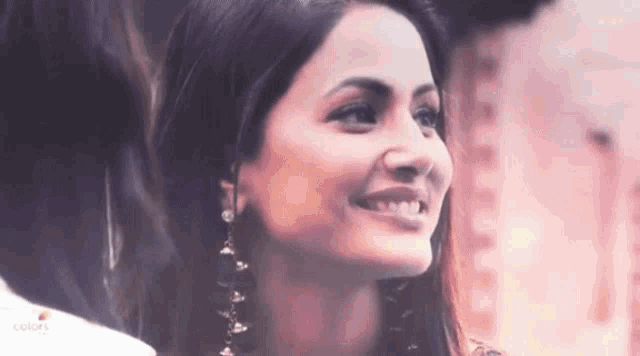 a close up of a woman 's face with a smile on it .