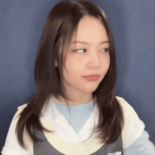 a woman wearing a shirt that says ' miu miu ' on the front