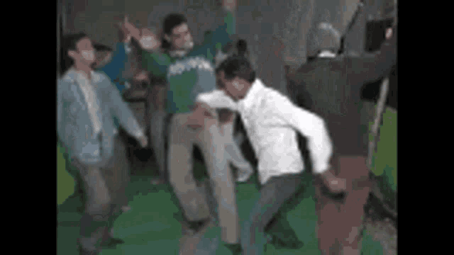 a group of people are dancing in a room with a green background .