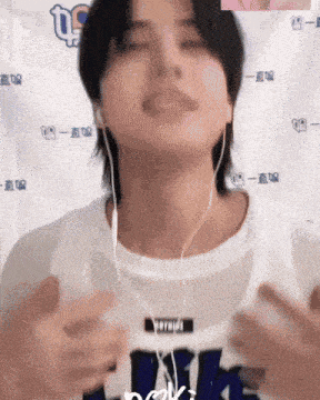 a person wearing headphones and a shirt that says ' nk ' on it