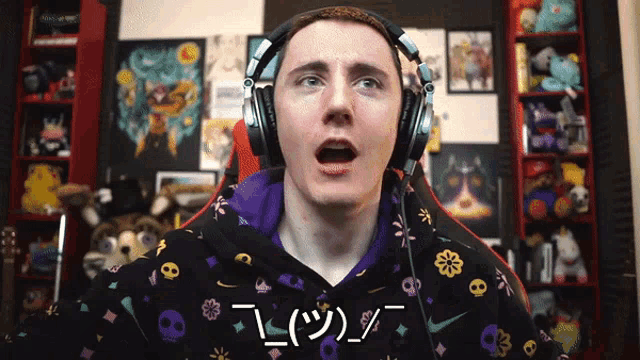 a man wearing headphones and a sweatshirt with skulls and flowers on it