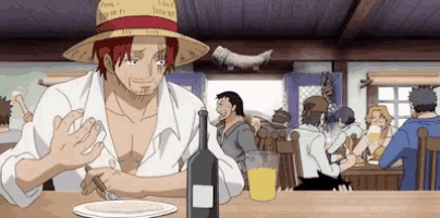 a man in a straw hat is sitting at a table with a bottle of wine