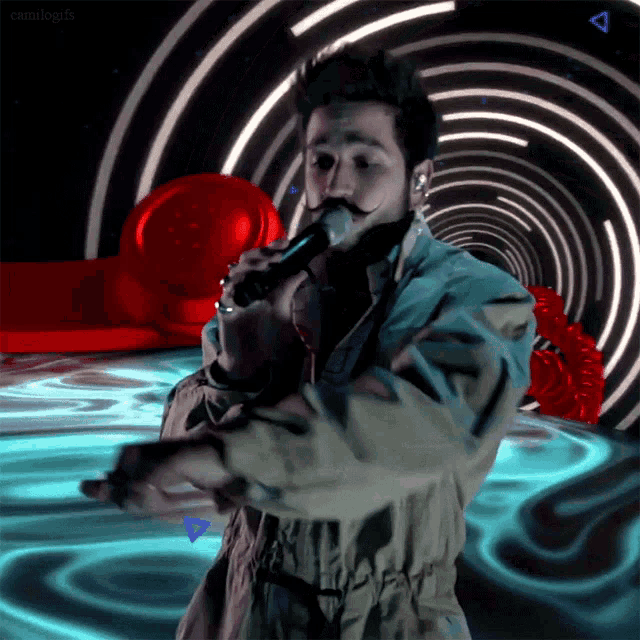 a man is singing into a microphone in front of a tunnel with a triangle in the middle
