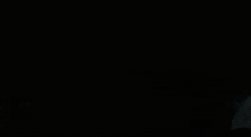a close up of a person 's face in the dark